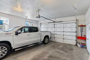 Garage featuring a garage door opener