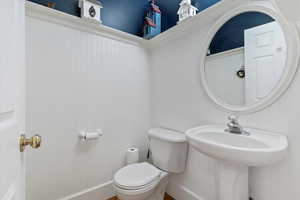 Bathroom featuring toilet and baseboards