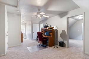 Home office with light carpet, a textured ceiling, and ceiling fan