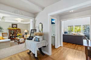 Living area with light wood-style flooring and a tray ceiling