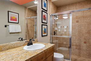 Full bathroom with vanity and a stall shower