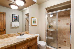 Full bathroom with vanity and a stall shower