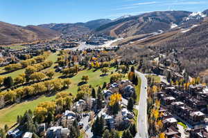 Aerial overview of property's location featuring nearby suburban area and a mountain backdrop