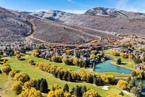 Aerial perspective of suburban area featuring a water and mountain view and a golf course