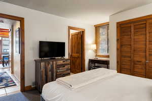Carpeted bedroom with a closet
