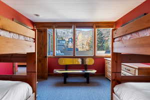 Bedroom with carpet, a baseboard heating unit, and a mountain view