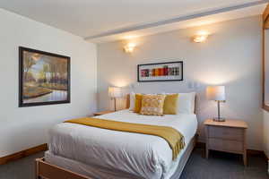 Bedroom featuring carpet floors and baseboards
