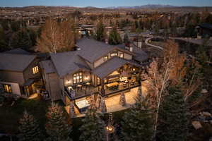 Bird's eye view of a mountain backdrop and a tree filled landscape