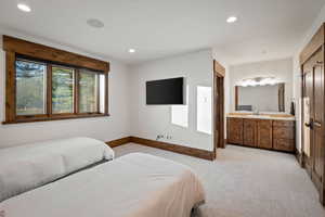 Bedroom featuring light carpet and recessed lighting