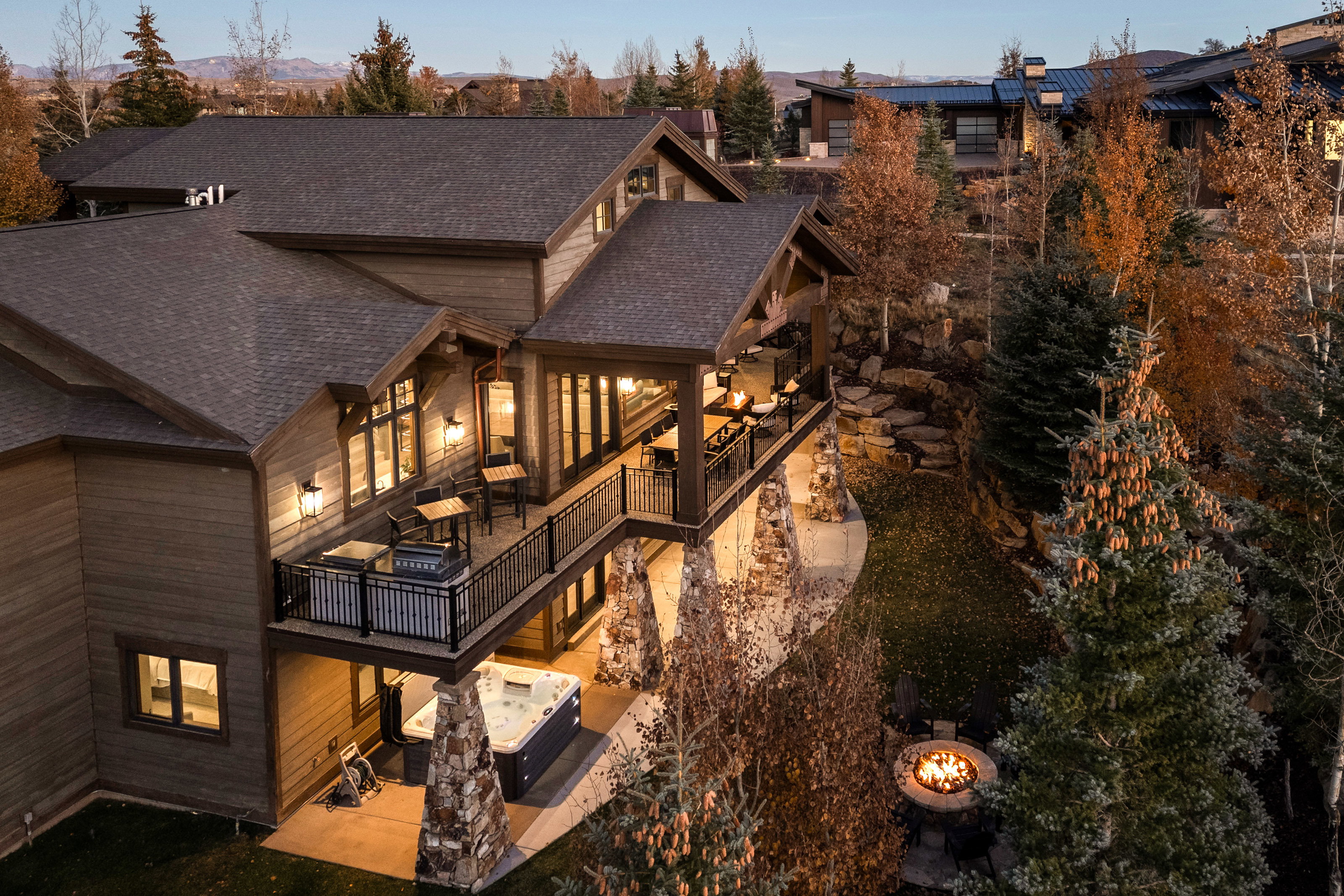Rear view of house featuring a patio area and roof with shingles