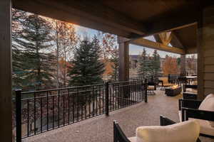 Balcony with a fire pit and view of scattered trees