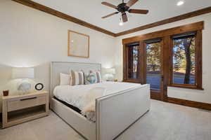 Bedroom with access to exterior, carpet flooring, ceiling fan, and crown molding