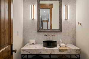Bathroom featuring decorative backsplash and vanity