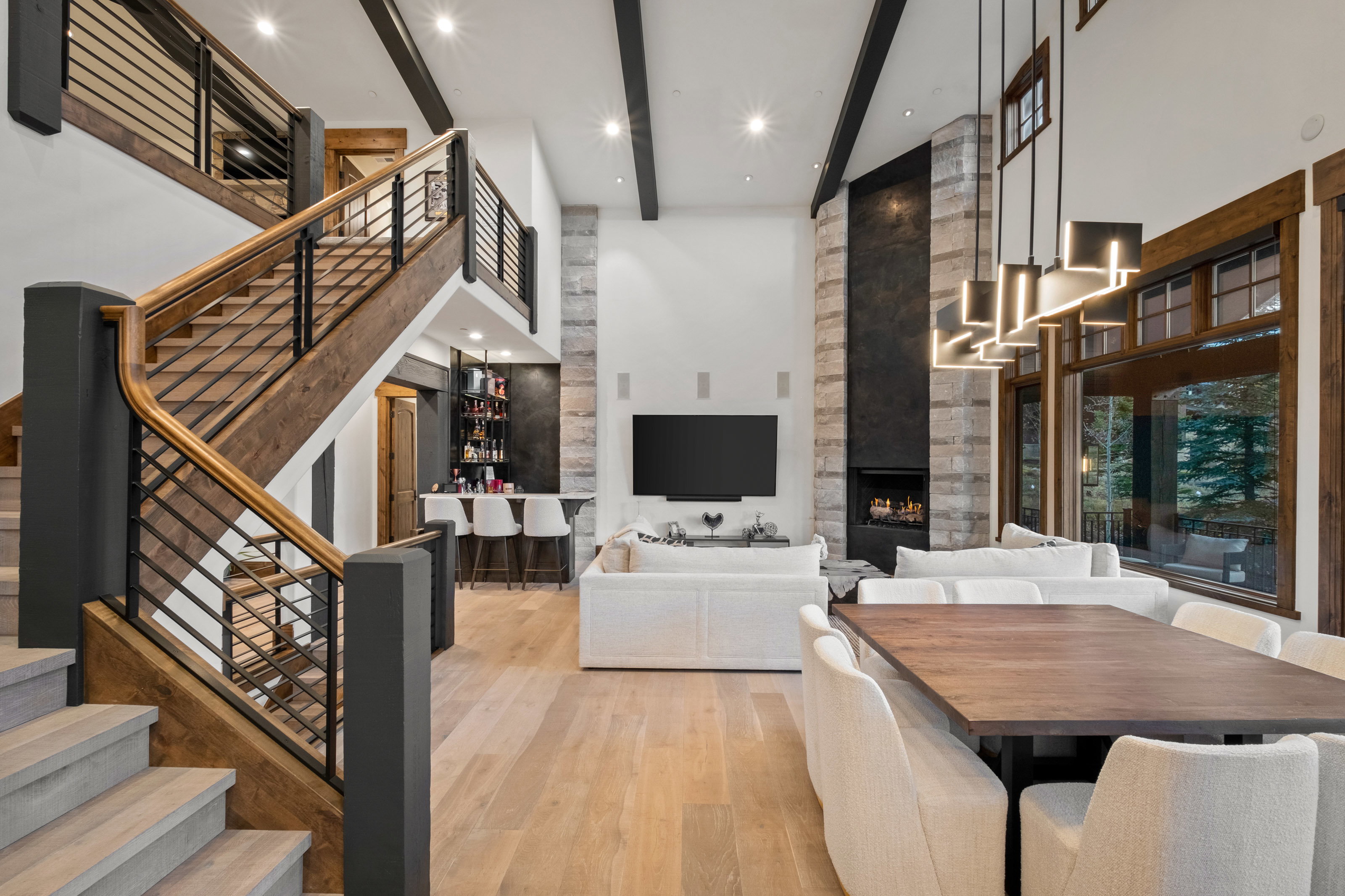 Dining space with light wood finished floors, a fireplace, and recessed lighting