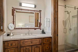 Full bath featuring vanity and a stall shower
