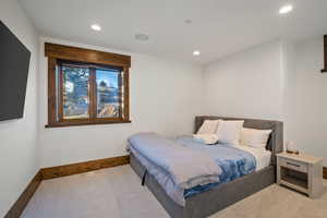 Carpeted bedroom with baseboards and recessed lighting