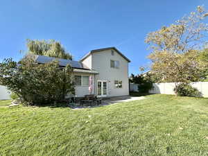 Rear view toward house, solar panels, picnic table, concrete landing