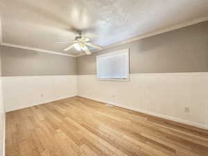Bedroom 2 upstairs with ceiling fan, bamboo flooring, and window with view to east mountain