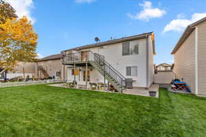 Back of house featuring a patio area, a fenced backyard, stairway, and a deck