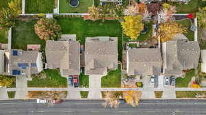 Aerial view of property and surrounding area featuring nearby suburban area