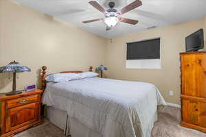Bedroom featuring carpet floors and ceiling fan
