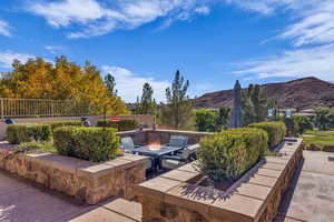 View of patio featuring an outdoor fire pit and a mountain view