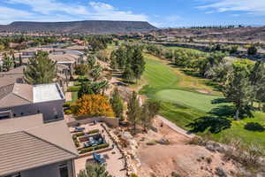 Aerial perspective of suburban area with mountains and a local golf course