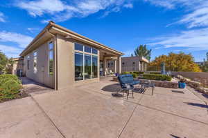 Rear view of property featuring a fenced backyard, stucco siding, and a patio