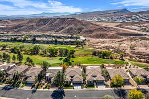 Aerial perspective of suburban area featuring mountains and a golf course