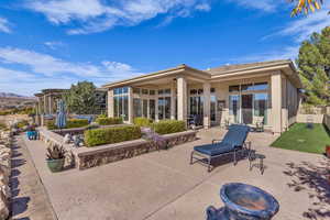Back of house with a patio and stucco siding