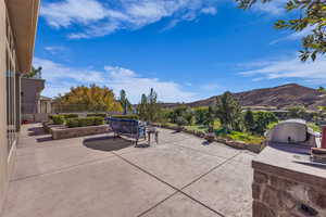 View of patio / terrace with an outdoor kitchen and a mountain view