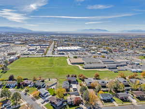 Aerial view of property's location featuring a mountainous background and nearby suburban area