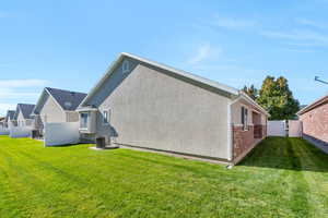 View of side of home featuring stucco siding and brick siding