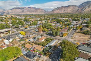 Aerial overview of property's location featuring a mountainous background and nearby suburban area