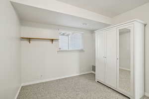 Unfurnished bedroom with a closet and light carpet
