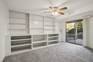 Unfurnished room featuring light carpet and a ceiling fan