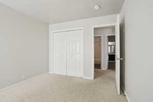 Unfurnished bedroom with carpet and a closet