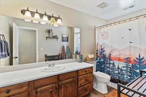 Bathroom featuring a shower with curtain, vanity, and tile patterned flooring