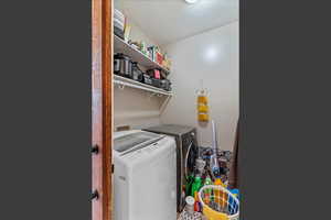 Laundry area with a textured ceiling and washer and clothes dryer