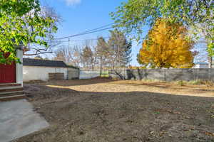 Fenced backyard featuring entry steps