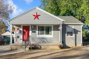 Bungalow-style home with covered porch and a shingled roof