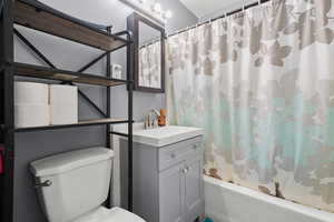 Bathroom featuring vanity and shower / bath combo with shower curtain