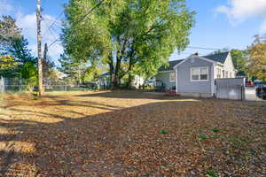 Fenced backyard featuring a gate
