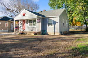 Bungalow with a chimney, a shingled roof, and a porch