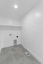 Laundry room with baseboards and washer hookup