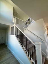 Stairway featuring wood finished floors and baseboards