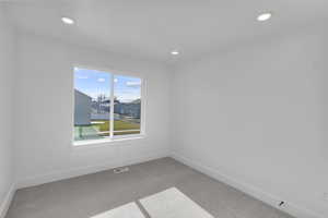 Spare room with carpet and recessed lighting