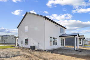 Rear view of property featuring a patio and stucco siding