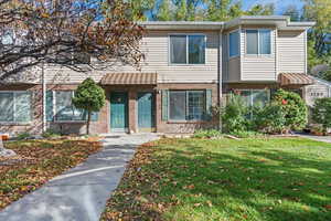 View of front of house with brick siding and a front yard