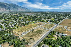Aerial overview of property's location featuring a mountainous background and nearby suburban area
